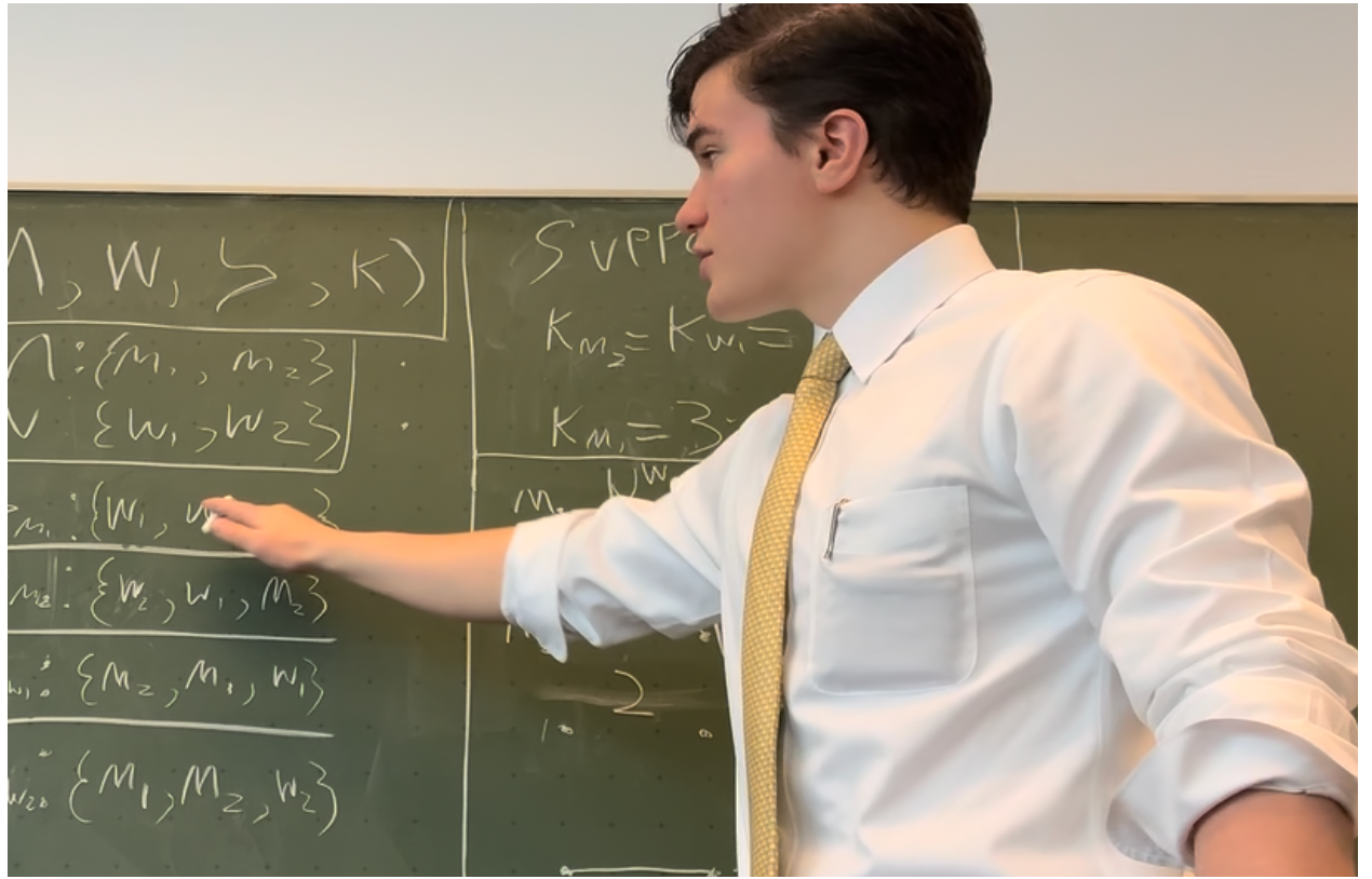 Stephen Laffey explaining matching theory at a chalkboard